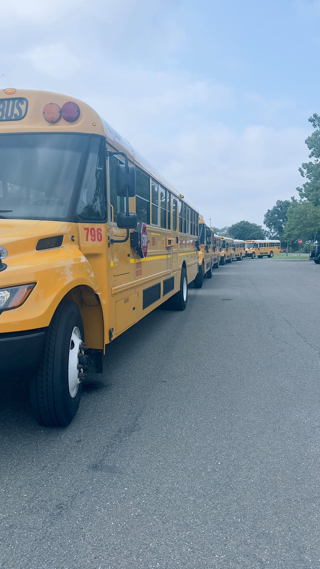 Independent Coach special needs vans and school buses at a Long Island yard.